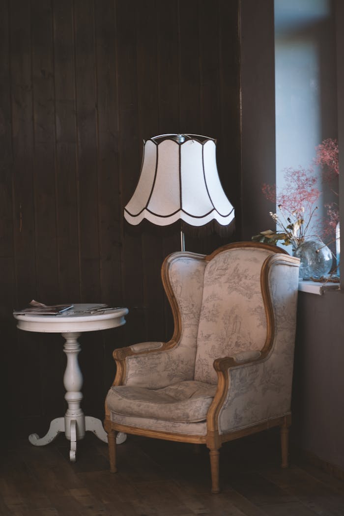 client-satisfaction-img Charming vintage interior with an armchair, elegant lamp, and side table. Perfect for cozy settings.